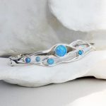 gw bng 001 wave bangle blue opals styled stone cradle